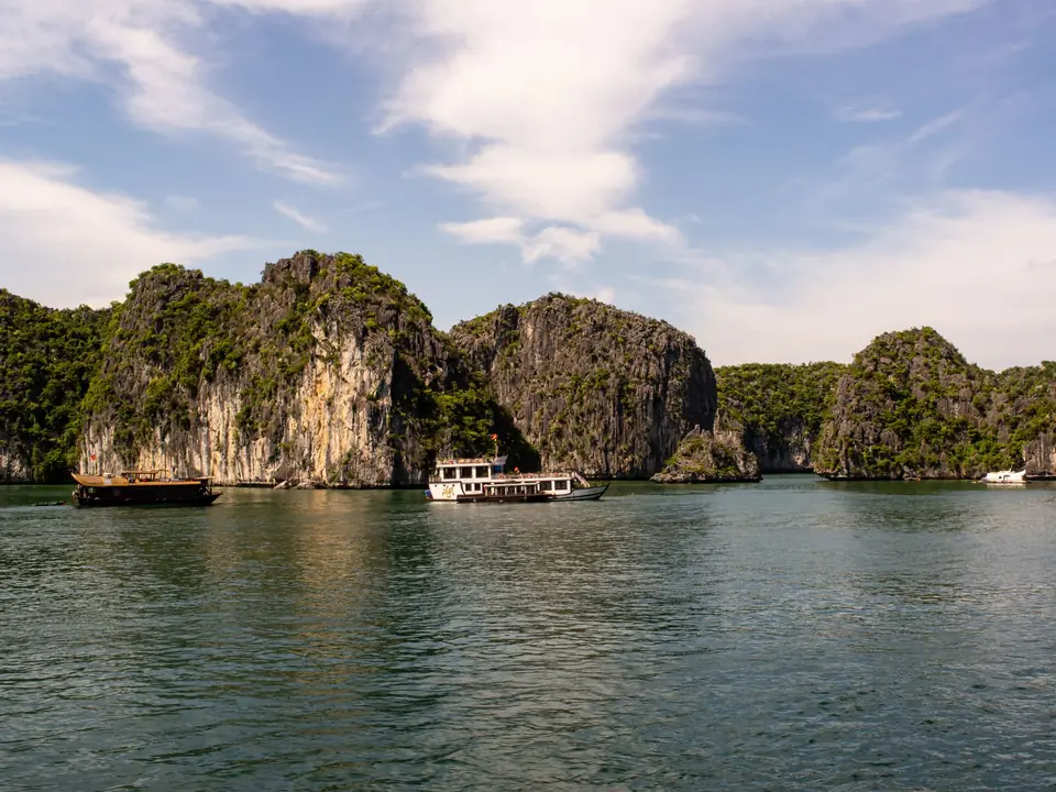 Stunning limestone karsts and boats in Ha Long Bay, Vietnam, under a clear sky