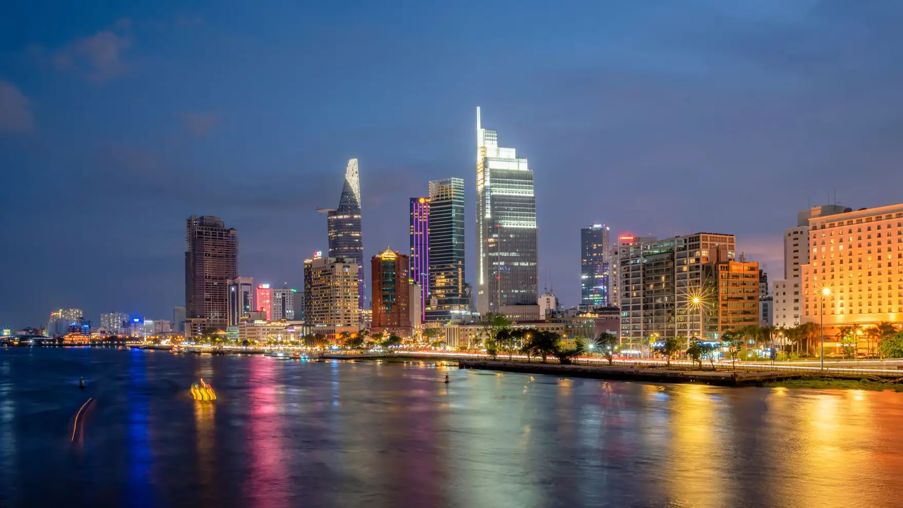 Stunning view of Ho Chi Minh City skyscrapers reflecting on the river at night