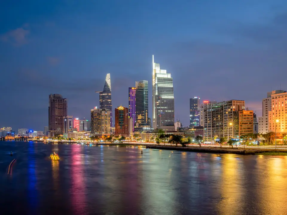 Stunning view of Ho Chi Minh City skyscrapers reflecting on the river at night