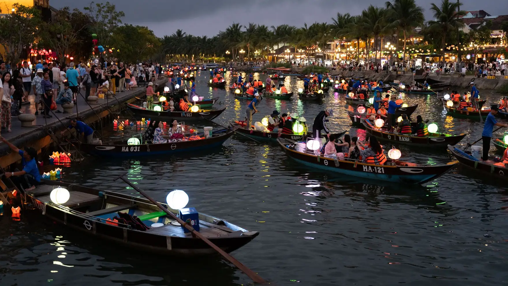 Boats filled with glowing lanterns during the traditional festival in Hội An, Vietnam, offering a vibrant cultural experience