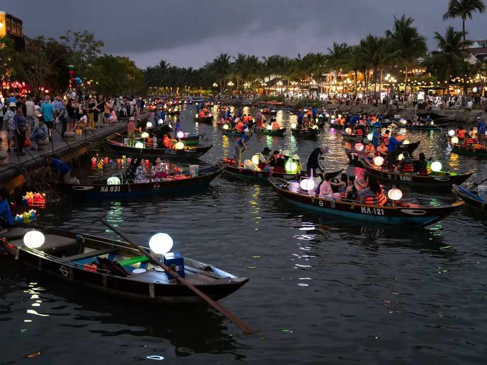 Boats filled with glowing lanterns during the traditional festival in Hội An, Vietnam, offering a vibrant cultural experience