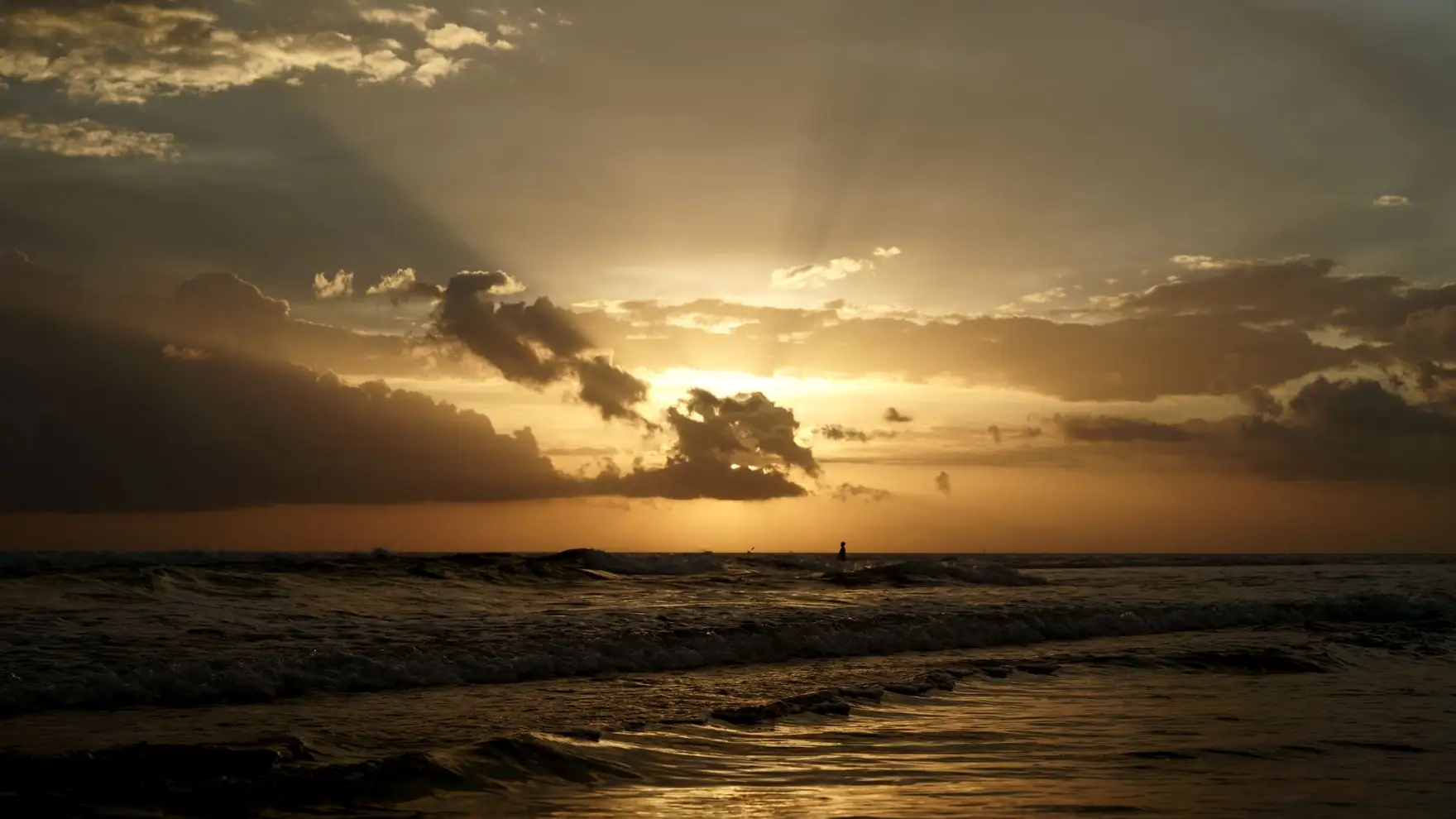 Calming sunset view at Kuta Beach, Bali with golden hues and gentle waves