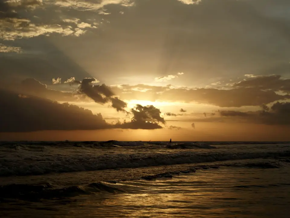 Calming sunset view at Kuta Beach, Bali with golden hues and gentle waves